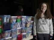 Sierra Swearingen, 15, of Battle Ground stands amid some of the 300 shoeboxes full of gifts that she collected for Operation Christmas Child.