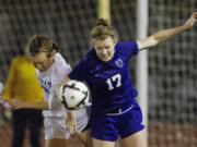 Columbia River's Katie Anthony, right, and Southridge's Syd Sanders battle for the ball during action in their rainy semi-final match in the 3A Girls State Soccer Championships in Puyallup, Wash. Southridge won the game 2-1 to advance.