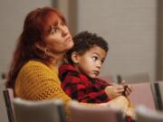 Yvette and Jayden Mercer get close during a World AIDS Day observance at the Unitarian Church in Vancouver on Monday night.