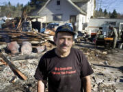 Ted Pyle in 2006, standing beside the remains of a structure on his property that he tore down and torched.