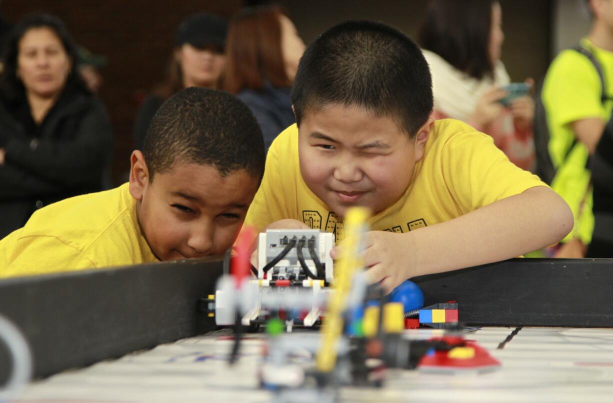 Banana Bot teammates Mohammed Alamin, left, and Dao Zhu compete in a robotics tournament Sunday at Salmon Creek Elementary School.