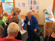 Margaret Colf Hepola, right, chats with Alexa Talvitie-Lynch at the La Center Community Library on June 25 to celebrate the 10th anniversary of the library.