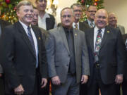 From left, Chief Criminal Deputy Mike Evans, Undersheriff Joe Dunegan and Sheriff Garry Lucas take photos with speakers at their retirement party at the Heathman Lodge Tuesday evening.