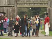 Doug Wilson, right, archaeologist at Fort Vancouver National Historic Site, greets visitors at the 2012 Fort Vancouver Christmas.