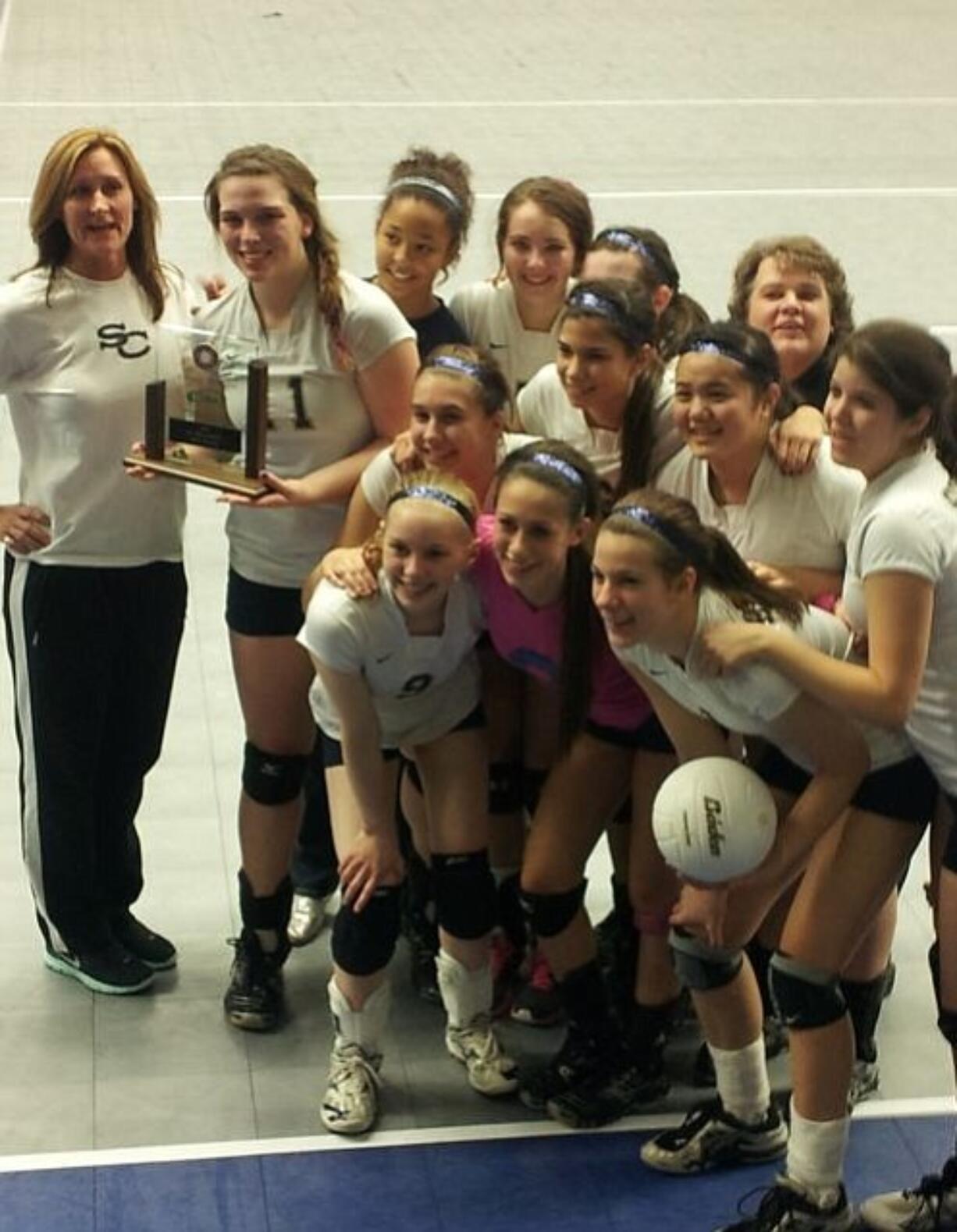 The Seton Catholic volleyball team poses with its third-place trophy after beating Christian Faith in five sets.