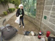 Photos by Steven Lane/The Columbian
Hough neighborhood resident Nancy Schultz, picking up trash in the Mill Plain Boulevard sound wall's alcoves in mid-May, would like to ensure the 2001 community tile art project on the walls are preserved if the alcoves are blocked off or torn down.