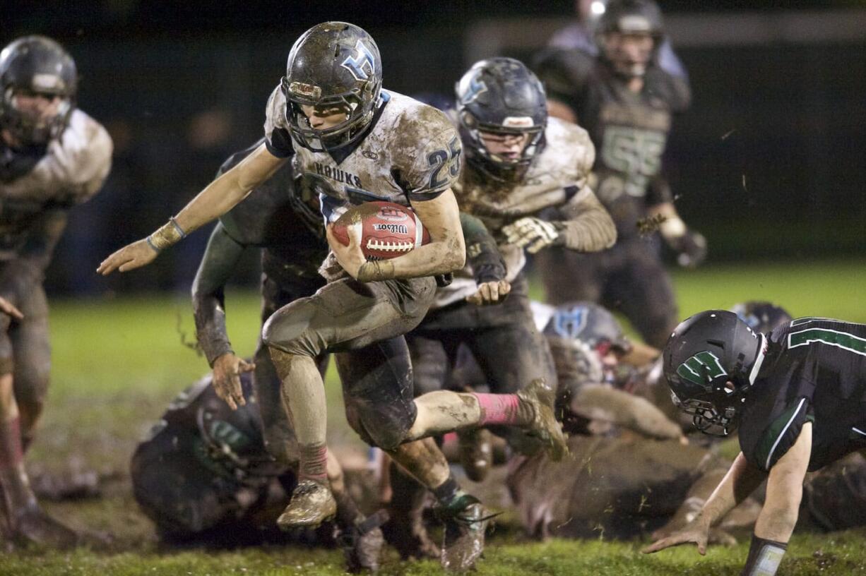 Hockinson's Tommy Harshaw breaks through and runs for a 67-yard touchdown to give the Hawks a 14-0 lead in the third quarter of their 14-7 road victory over Woodland.