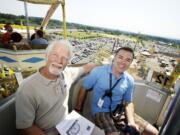 William &quot;Skip&quot; Ferris, left, and his son Matt Ferris ride The Big Wheel at the Clark County Fair on Monday .