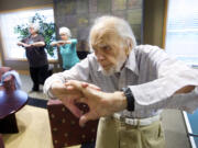 Harris Dusenbery, 100, and other Heritage Place residents take part in their regular workout session earlier this month.