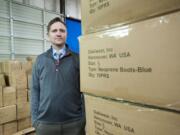 Ben Brewer, owner of Oakiwear, stands amid his inventory at his warehouse in Vancouver on Thursday.