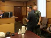 Paris Achen/The Columbian
John Garrett Smith is escorted out of a Clark County courtroom Wednesday after Superior Court Judge Robert Lewis found him guilty of second-degree attempted murder.