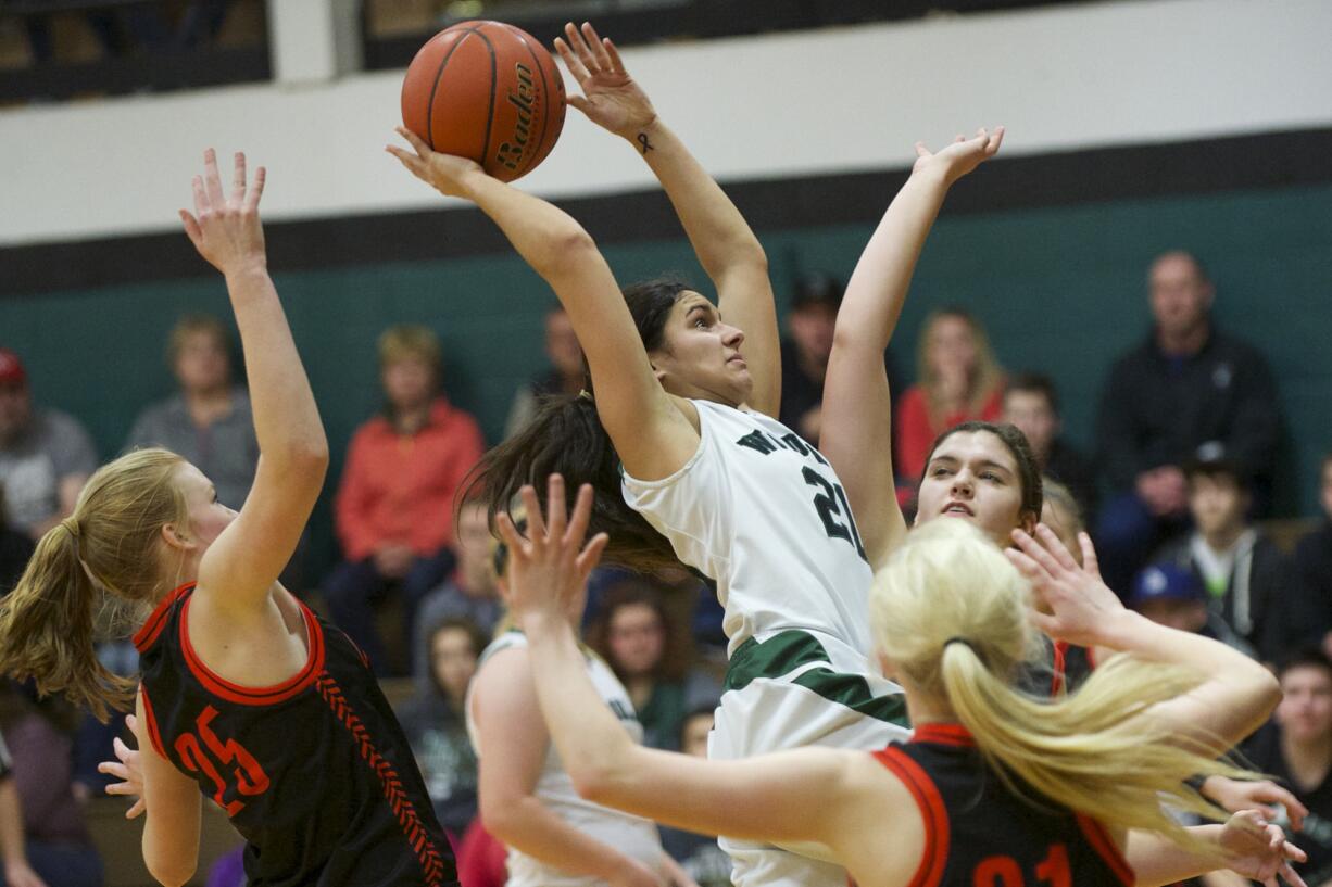 Woodland's Amber Malik, 21, is fouled by the Centralia defense in the 2A district playoffs, Friday, Feb.