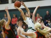 Woodland's Amber Malik, 21, is fouled by the Centralia defense in the 2A district playoffs, Friday, Feb.