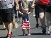 Annalee Symons, 2, from Boise, Idaho, arrives with her parents Logan and Jenni Symons at Independence Day at Fort Vancouver.