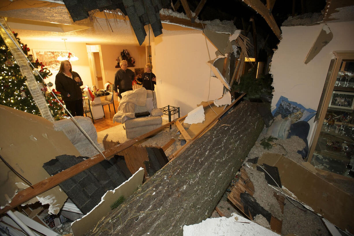 A large fir tree split the home of Ken and Sharon Thiesmeyer as high winds blew through Clark County on Thursday.