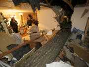 A large fir tree split the home of Ken and Sharon Thiesmeyer as high winds blew through Clark County on Thursday.