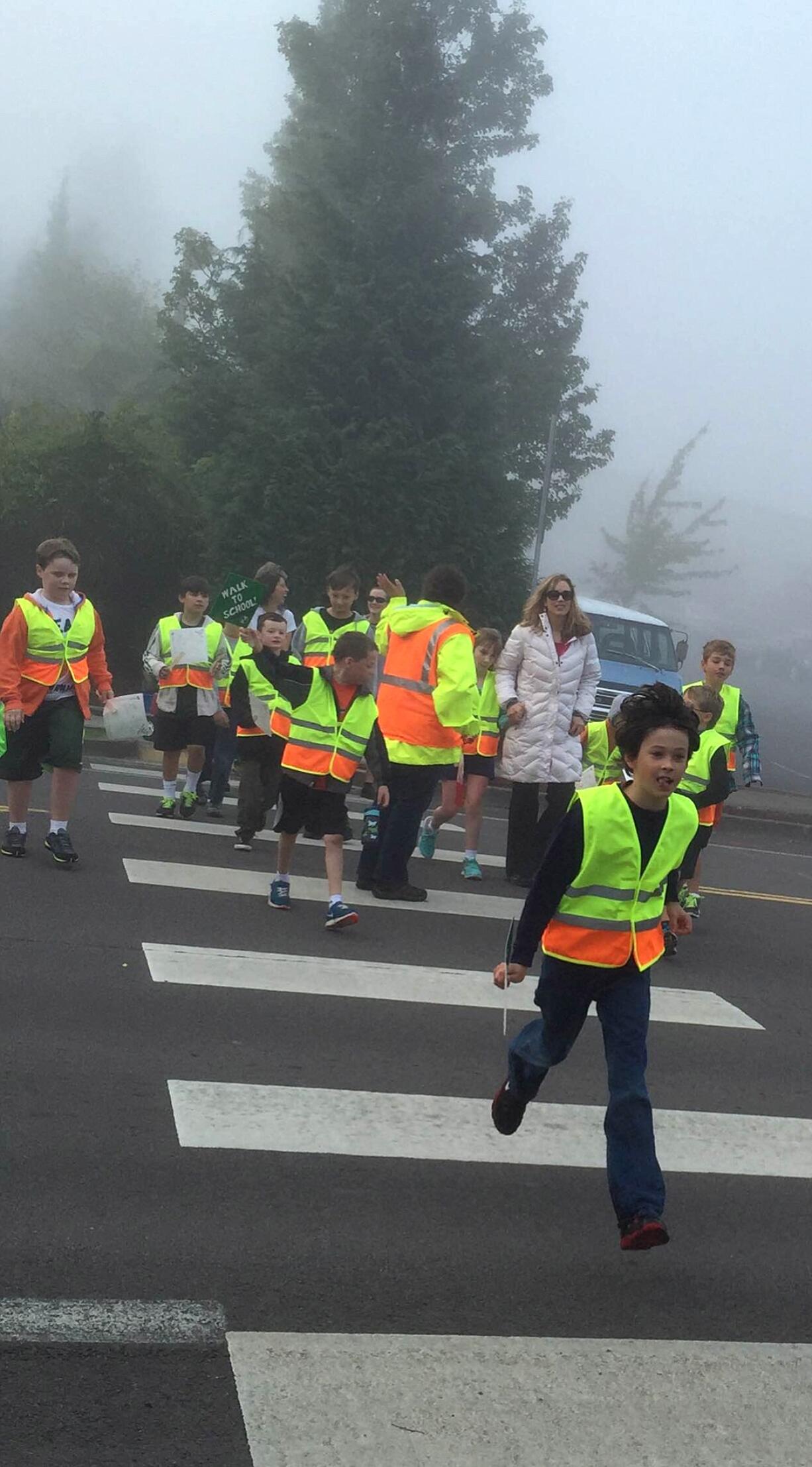 Camas: Aran O'Day, 9, leads a group of other Grass Valley Elementary students in crossing the street on Oct.