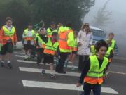 Camas: Aran O'Day, 9, leads a group of other Grass Valley Elementary students in crossing the street on Oct.