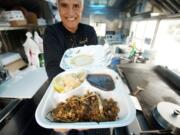 Chester-Castillo Morales, owner of the Tacos n' Cream food truck, shows the El Chico Plato chicken taco meal on Jan.