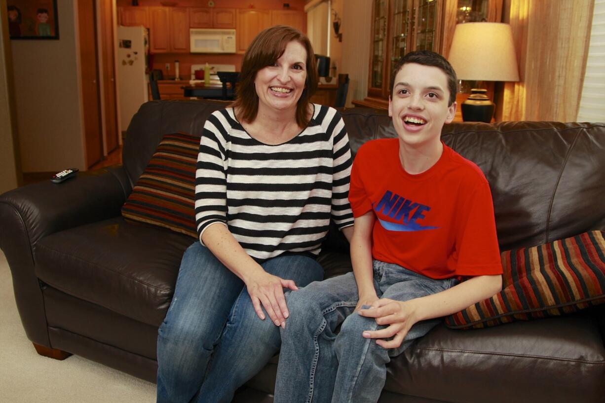 Steve Dipaola for The Columbian
Kari Sullivan and her 14-year-old son Nick pose for a portrait at their home in east Vancouver. Nick, who has autism and difficulty communicating, had trouble talking with paramedics when he fell and broke his hip this summer. His family is trying to figure out ways to better work with first responders when there's an emergency.