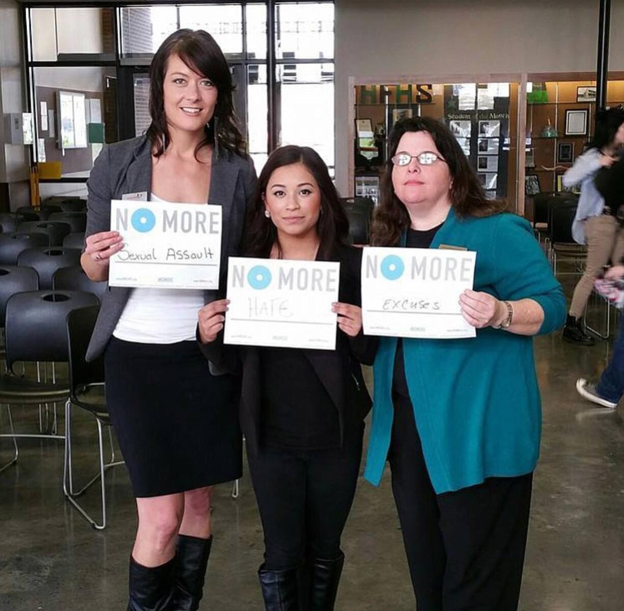 Camas: Lindsay Holmes, left, student Daniela Garcia and Michelle Bart take a stand at Hayes Freedom High School on March 6.