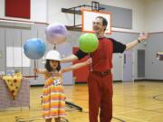 Washougal: Maya Hopkins, left, and Jugglemaniac Rhys Thomas put the law of gravity to the test on June 7.