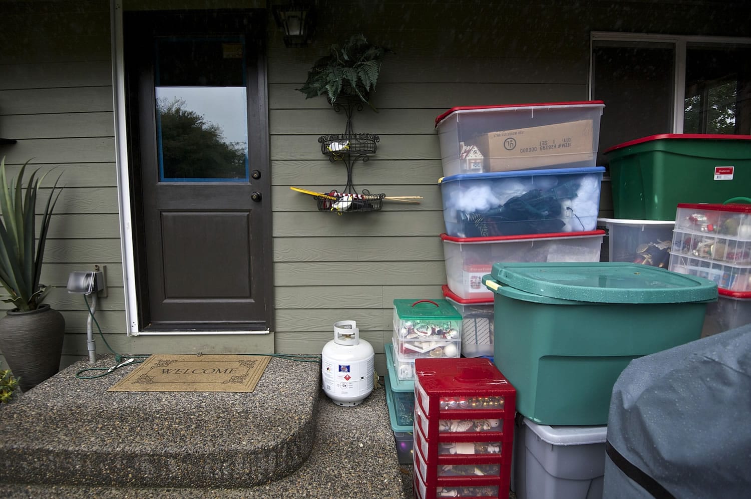 Christmas decorations belonging to Shelly and Craig Johnson sit in containers near the back door of their Vancouver home Monday.