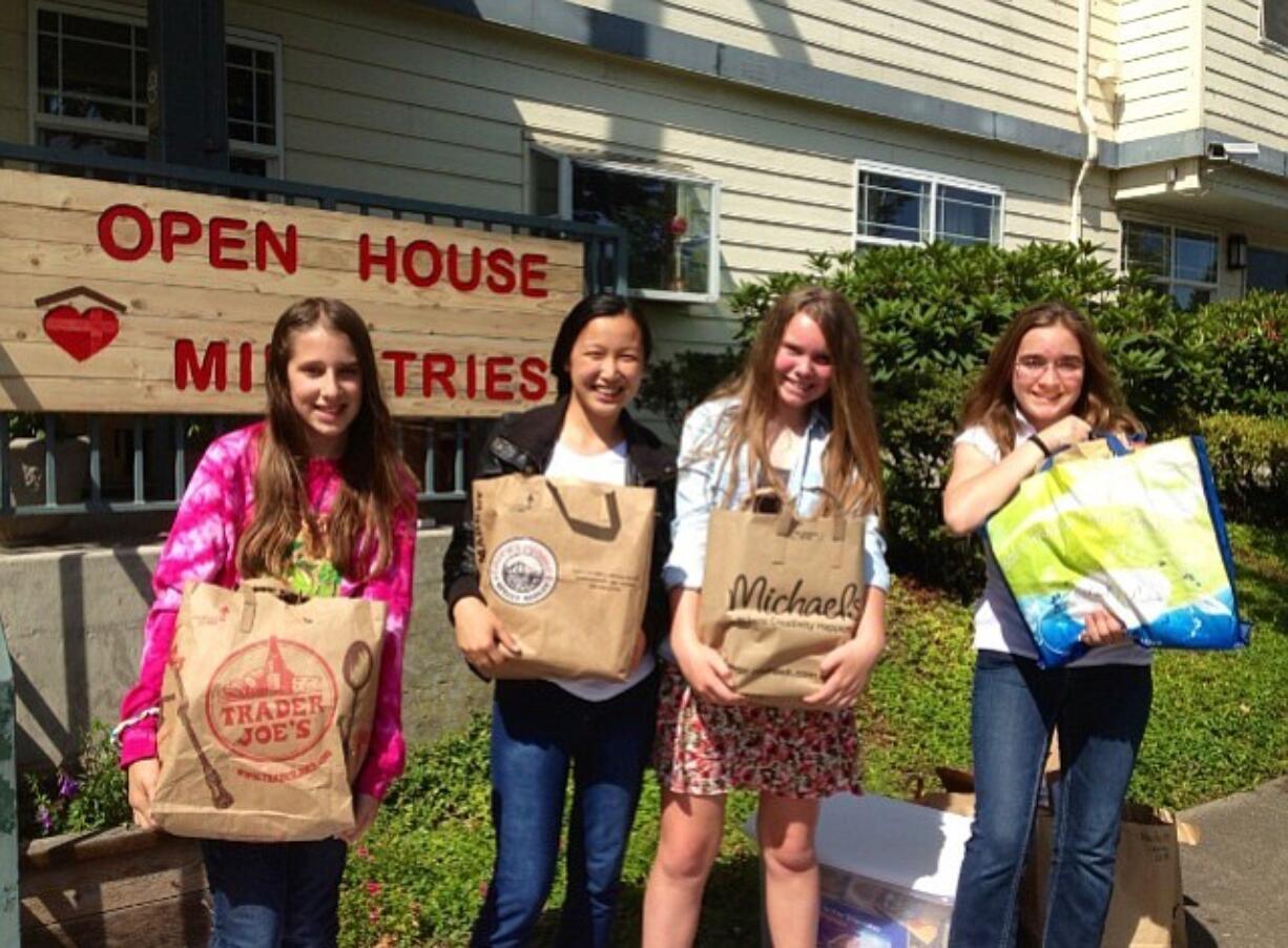 Hazel Dell: King's Way Christian School sixth-graders Sydney Agan, from left, Ellie Dick, Sara Thudium, and Stephanie Clark donating 771 books collected at the school's book drive to Open House Ministries.