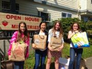 Hazel Dell: King's Way Christian School sixth-graders Sydney Agan, from left, Ellie Dick, Sara Thudium, and Stephanie Clark donating 771 books collected at the school's book drive to Open House Ministries.