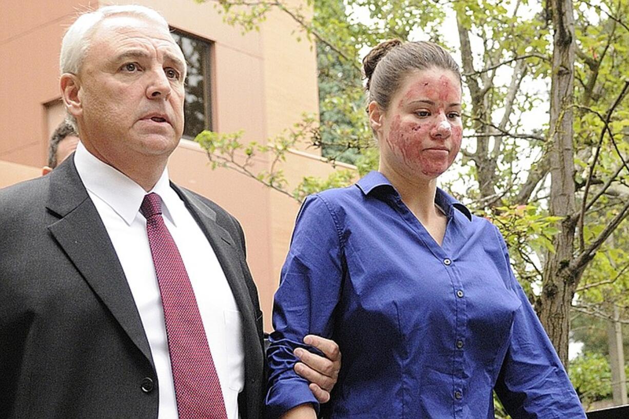 Bethany Storro is escorted by Vancouver police detective Wally Stefan, the lead investigator in her case, to the Clark County Jail for processing after her first court appearance in September.