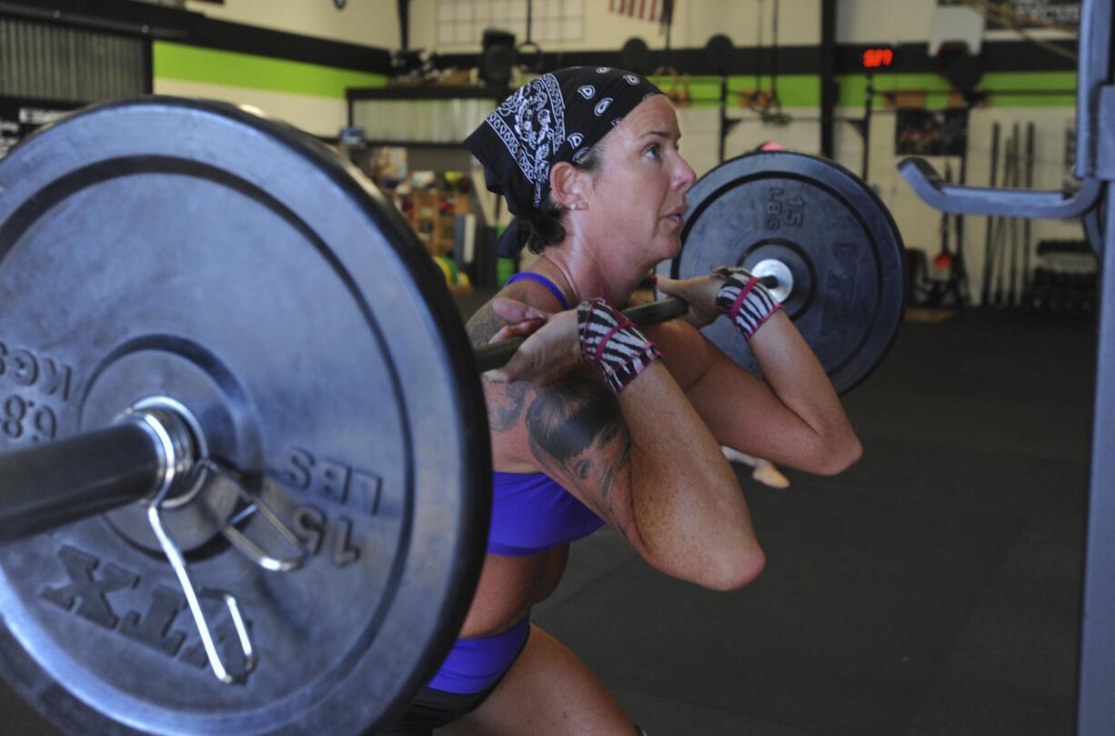 Susan Gotshall, 43, works out Aug. 25 at CrossFit Untamed in Vancouver. Gotshall said CrossFit put her in the best position -- physically, mentally and emotionally -- to go through her breast cancer diagnosis, surgery and recovery.