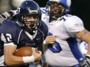 Parker Henry (L) of Skyview runs for a touchdown against Coeur d'Alene during the first quarter of high school football game Saturday night at the Kiggins Bowl.