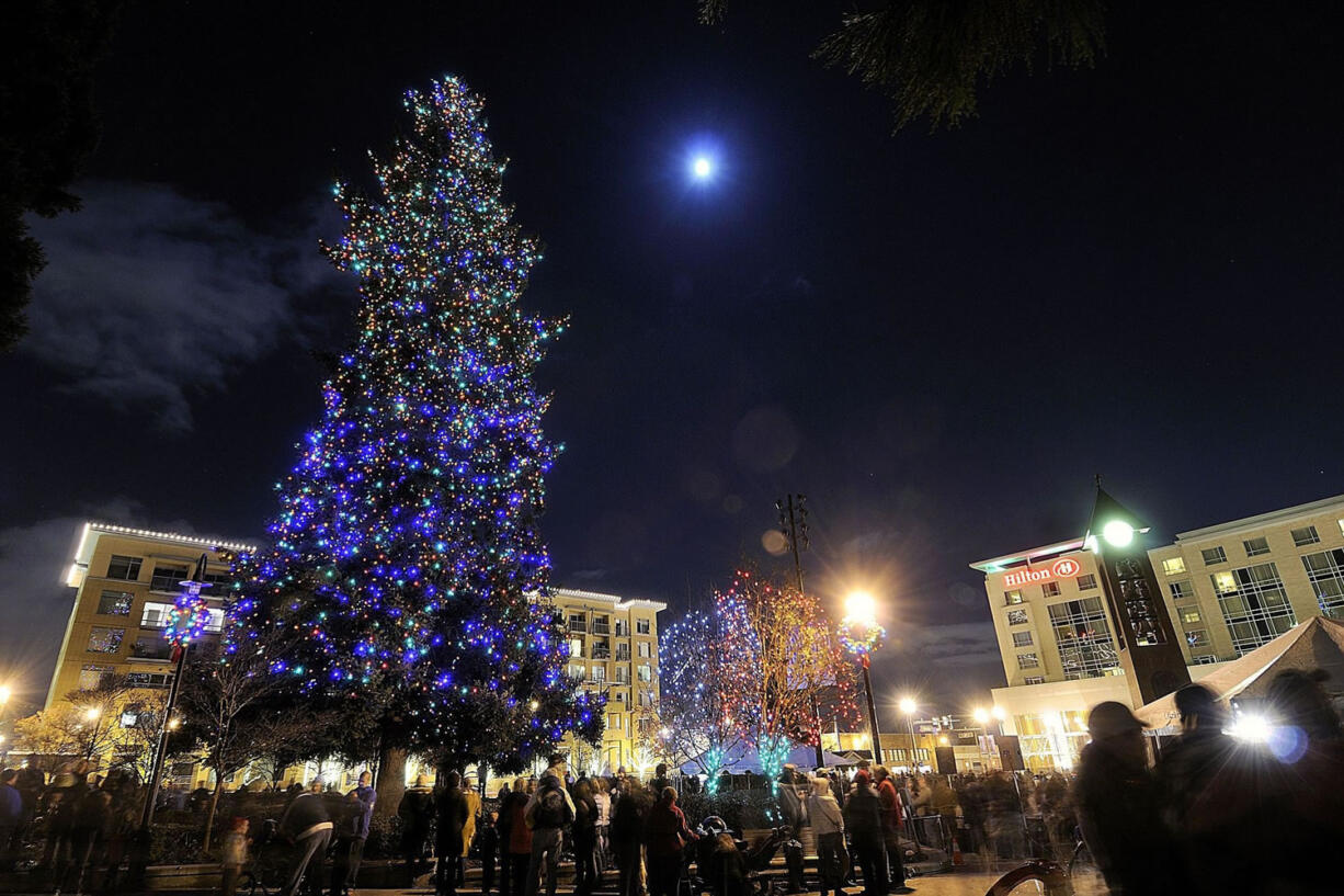 Thousands gather to hear a Christmas choir, celebrate the arrival of Santa Claus and watch the annual lighting of the Christmas tree at Esther Short Park in 2009.