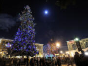 Thousands gather to hear a Christmas choir, celebrate the arrival of Santa Claus and watch the annual lighting of the Christmas tree at Esther Short Park in 2009.