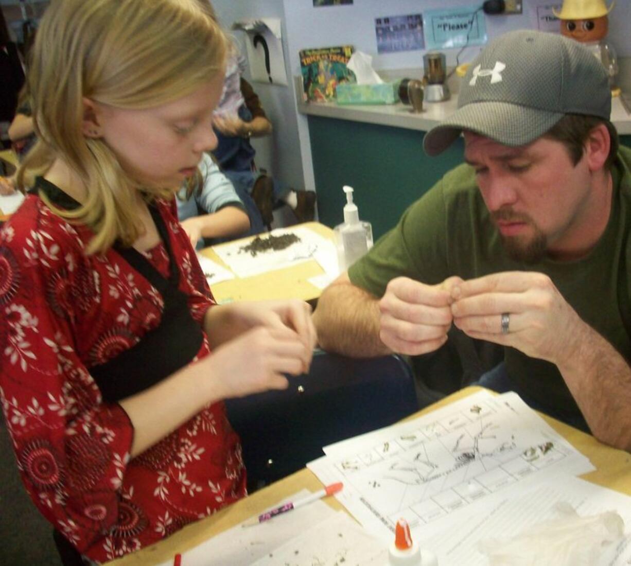 Woodland: Keygan Waliezer and her father, Greg Waliezer, dissect owl pellets for science class Feb.