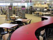 Ryan Ellis, Cascade Park Community Library supervisor, helps stock the shelves in the new facility shortly before it opened in December 2009.