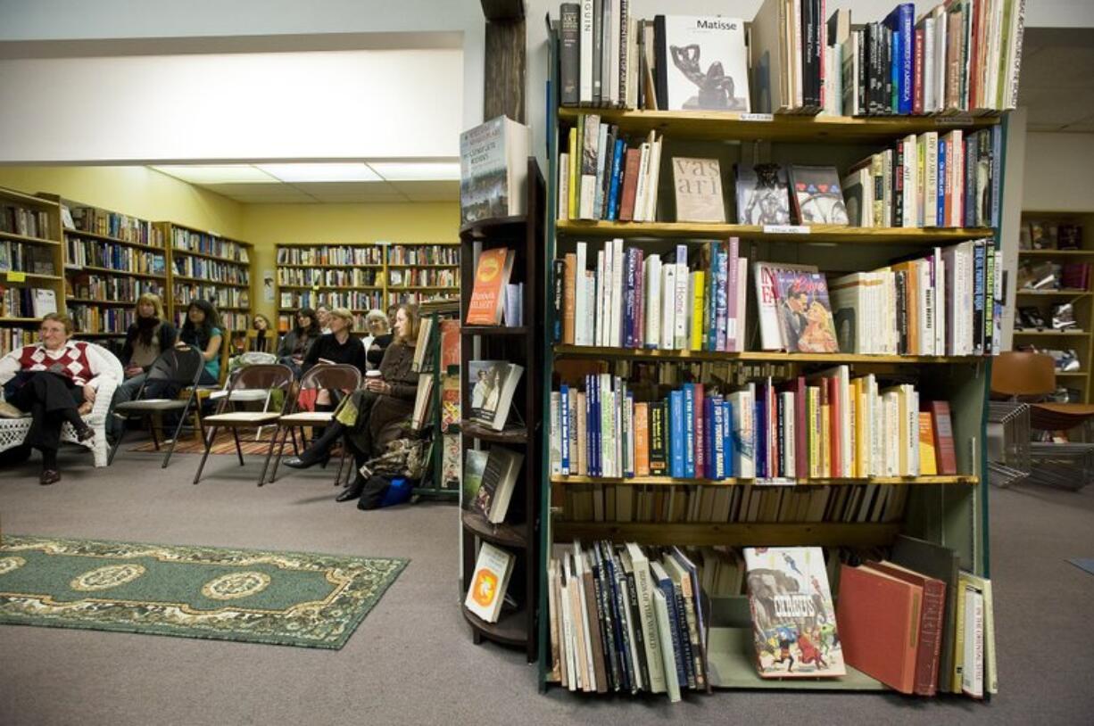 A small crowd listens to a reading at Cover to Cover Books.