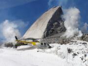 A helicopter flies past a &quot;slab&quot; of the freshest rock on the planet midway through Mount St.