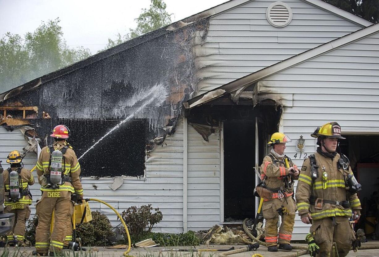 Crews from Fire District 6 attend to a fire that caused heavy damage to a home on NW 78th Street on Monday April 19, 2010. A family dog and cat fell victim to the blaze, but nobody else was injured.