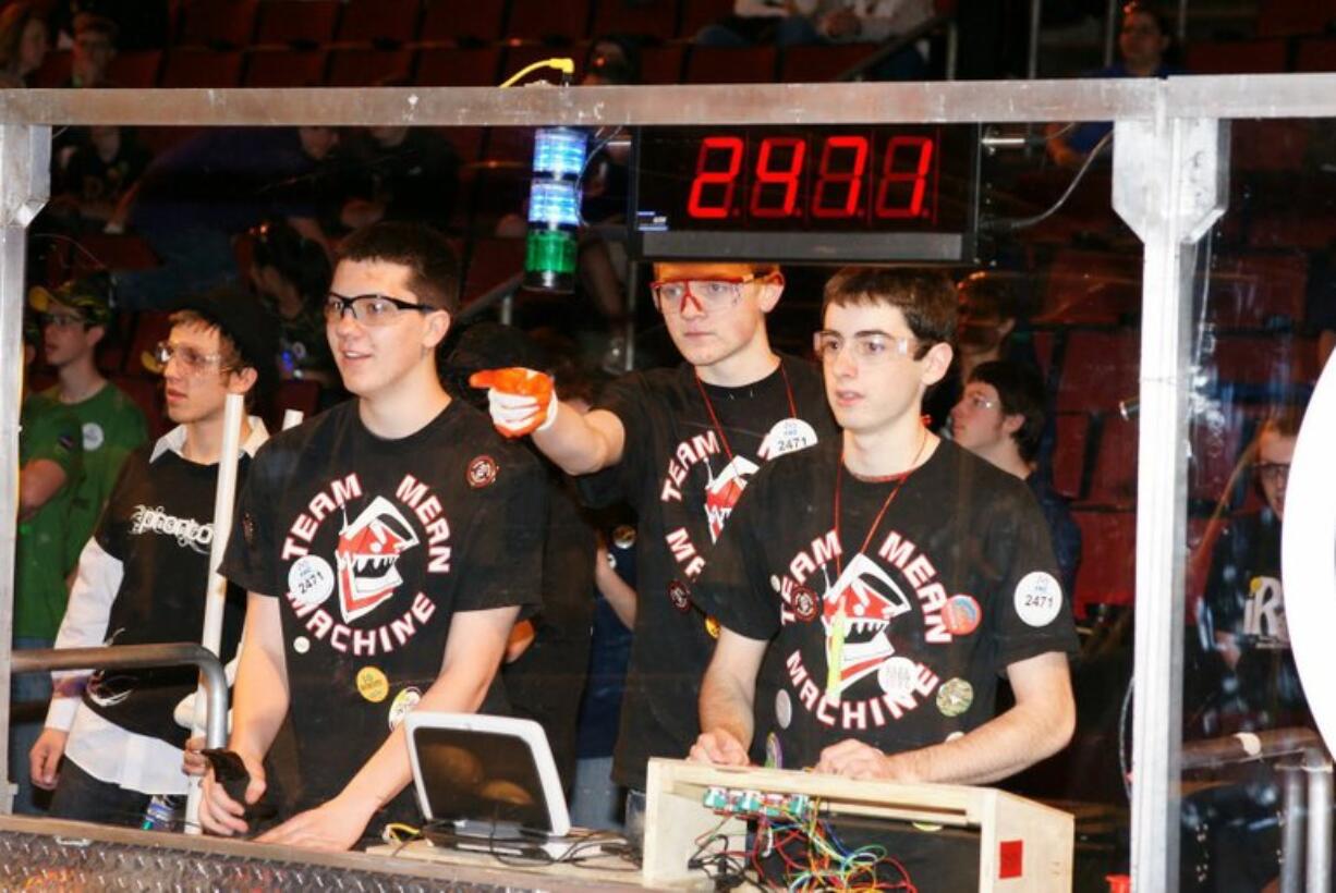 Camas/Washougal: Jordan Mazi, Patrick McCarthy and Henry Midles remotely control the team's robot at the Microsoft FIRST Robotics Seattle Regional.