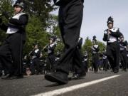 Heritage High School band members march under sunny skies before a crowd estimated at 40,000.