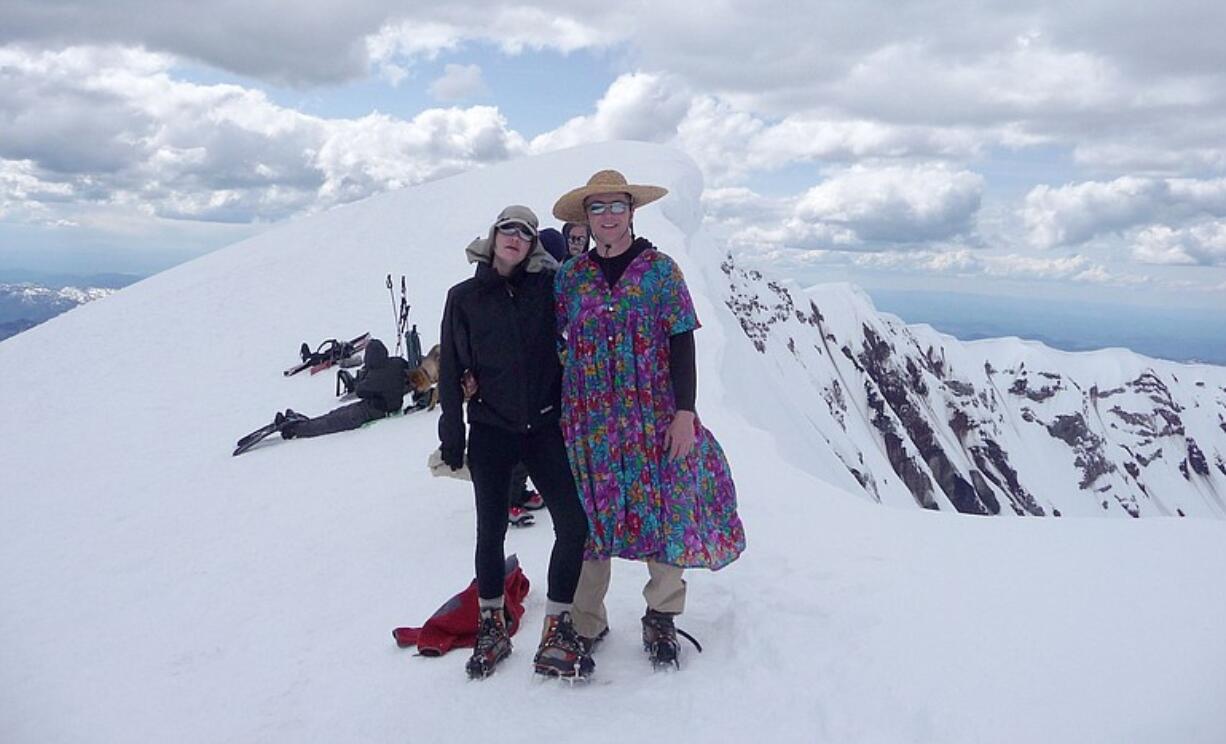 Tracy Patrick, left, and Steve Fuhr of Yacolt pause at the summit rim of Mount St. Helens.