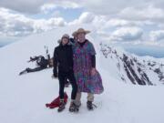 Tracy Patrick, left, and Steve Fuhr of Yacolt pause at the summit rim of Mount St. Helens.