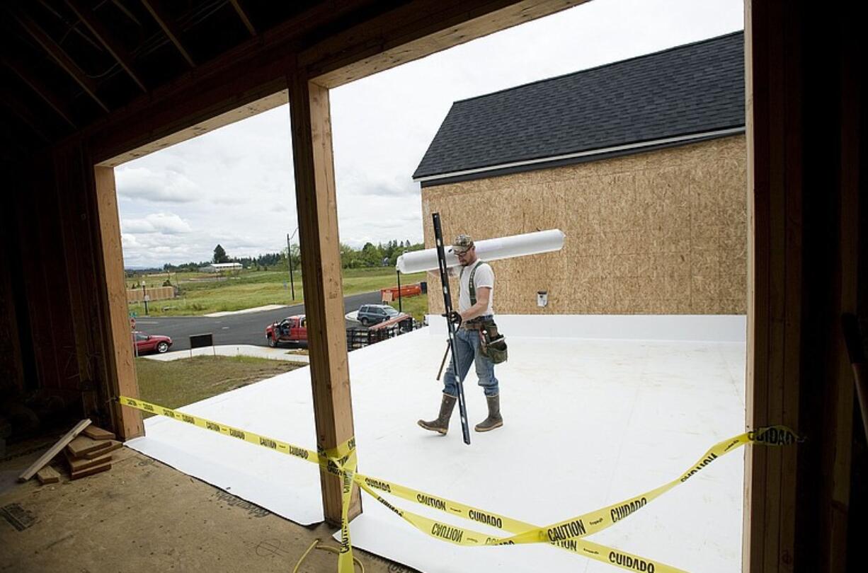 Marshall Hatfield from JXL Siding walks on a rooftop deck Monday that will become a semi-private courtyard for a Ridgefield home that will be showcased at the Parade of Homes in July.