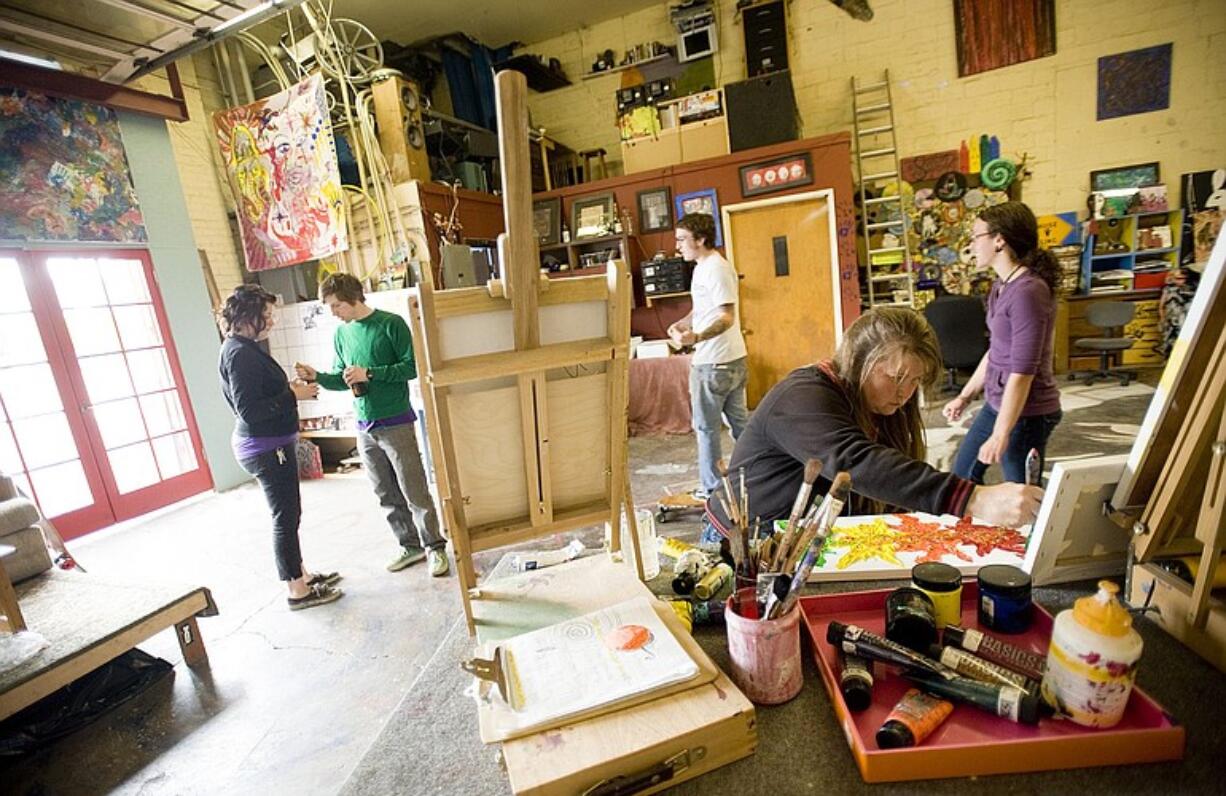 Colleen Lindsay, foreground, paints at The Space Artists Collective.