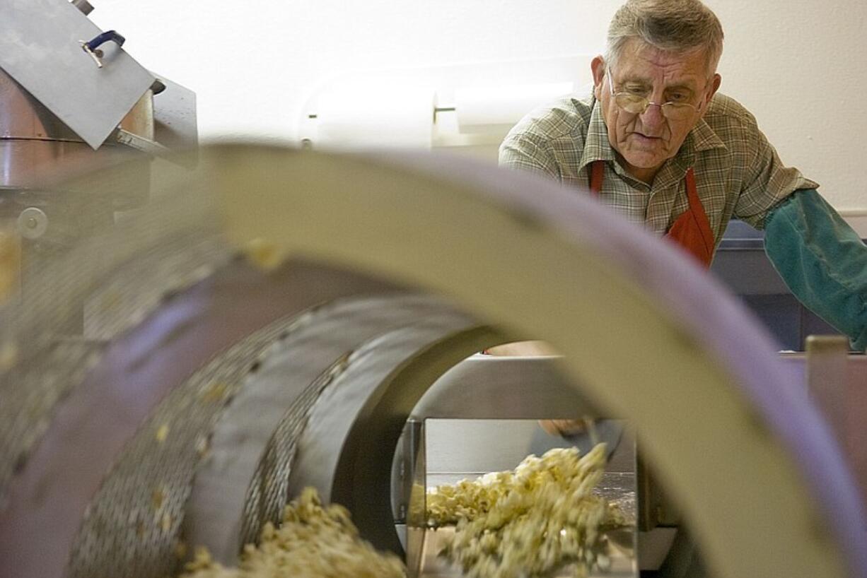 Allen Anderson makes kettle corn Wednesday for Parody Shops in airports across the nation in his store, Daisy Maiz, 607 Washington St. in downtown Vancouver.