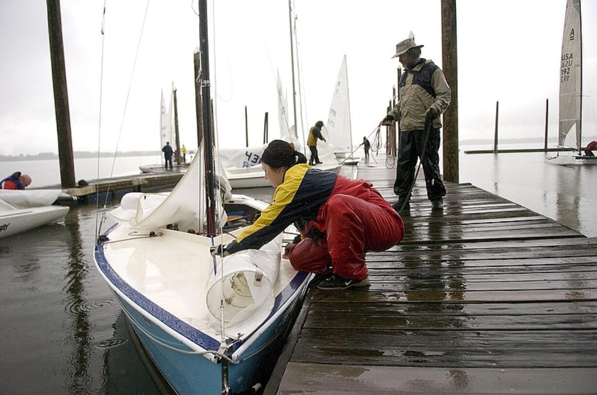 Hannah Hobbs, left, and Bruce Harrington ready their sailboat Sunday for the drive home from Vancouver Lake.