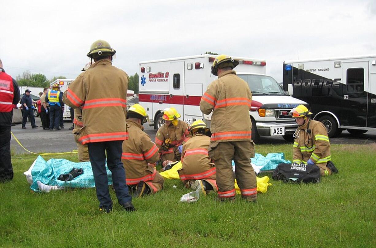 Agencies from around the region (a Battle Ground police van is at the right) respond to a simulated shooting incident.