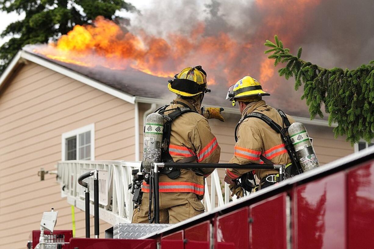 Vancouver firefighters work on a fire at 2306 Thompson Ave., early Thursday evening.