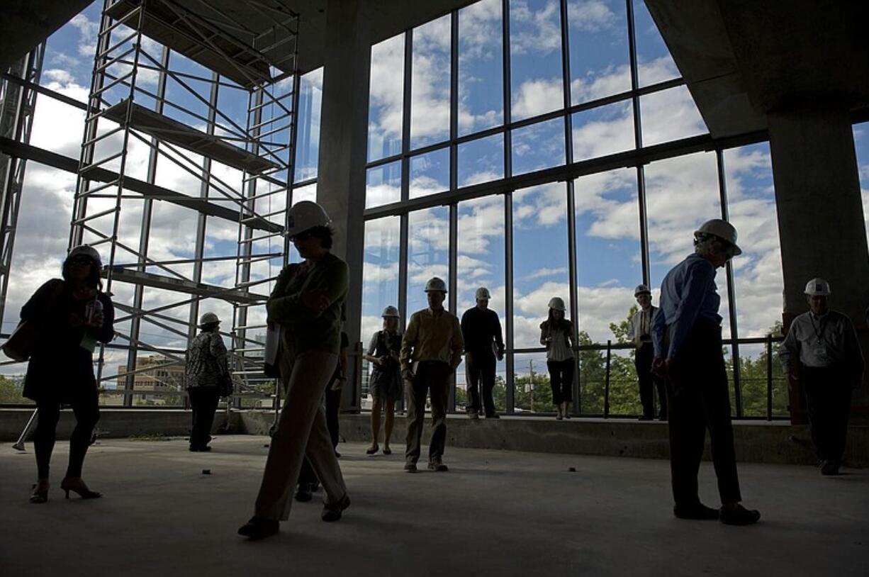 Visitors on a special tour on Tuesday get an early look at the northwest view from the fourth floor of the new Vancouver Community Library under construction downtown. A small atrium rises to the fifth floor.